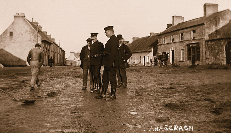 Two policemen walk the streets of Ahascragh around 1900.
