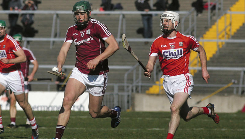 Galway's Niall Burke breaking away from Cork's Brian Lawton during Sunday's National Hurling League Division 1A relegation play-off at Pearse Stadium. Photo: Enda Noone.