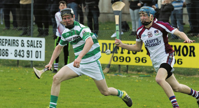 Mullagh's Stephen Cahalan and Kilnadeema/Leitrim defender Tony Molloy chase this loose ball in the Senior B hurling championship tie in Killimor on Sunday. Photos: Joe Keane.