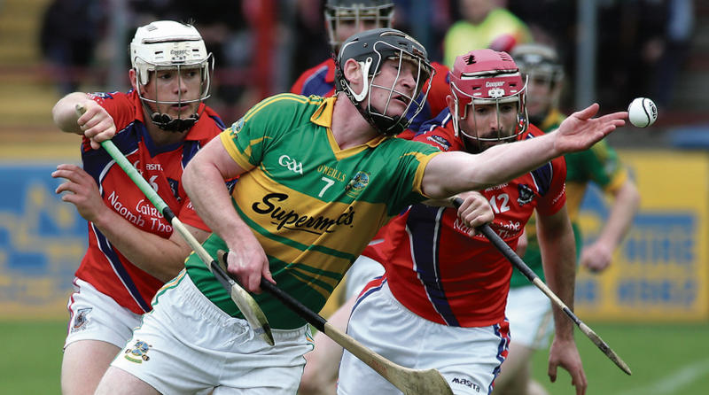 Gort's Sylvie Linnane stretches to get the sliotar away as James Regan and Darragh Burke of St Thomas challenge. Photo: Joe O'Shaughnessy.