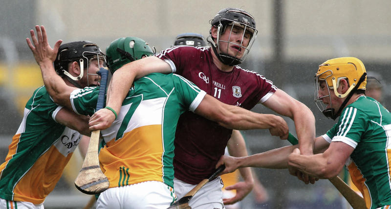 Galway's Joseph Cooney smashes through the Offaly defence in last Sunday's Leinster semi-final. Photos: Joe O'Shaughnessy.