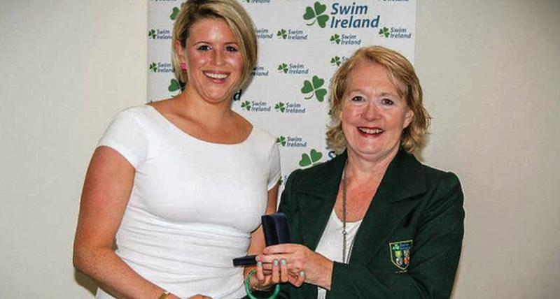 Galway swimmer Alice Flood (left), seen here receiving a silver medal at a Sea Swim medal ceremony from then Swim Ireland President Anne McAdam, is aiming to become the first Galway person to swim the English Channel.