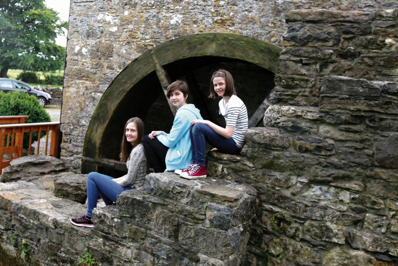 Emily, Miriam and Lilian Kennedy at the mill wheel of Finnerty's Mills, Loughrea which was restored to working order by their parents