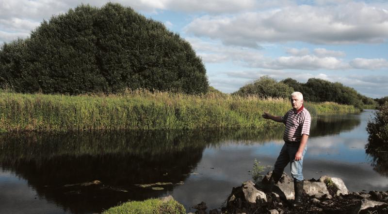 IFA activist and Shannon Callows farmer, Tom Turley, pictured on Monday evening last on the edge of the River Shannon at Derryholmes near Clonfert at one of the pinch points on the River Shannon where silt and unchecked growth are choking the water flow along the channel. (See story in main paper). PHOTO: HANY MARZOUK.