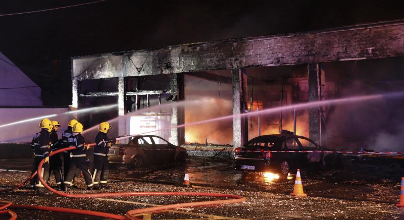 Fire fighters prevent the fire from spreading at Shannon Dry Cleaners early on Wednesday morning. Photos: Joe O'Shaughnessy.