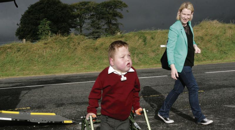 Five-year-old Liam Mac an tSaoi arriving for his first day at Clonberne NS yesterday accompanied by his nurse, Jacinta Sexton. Photo: David Walsh