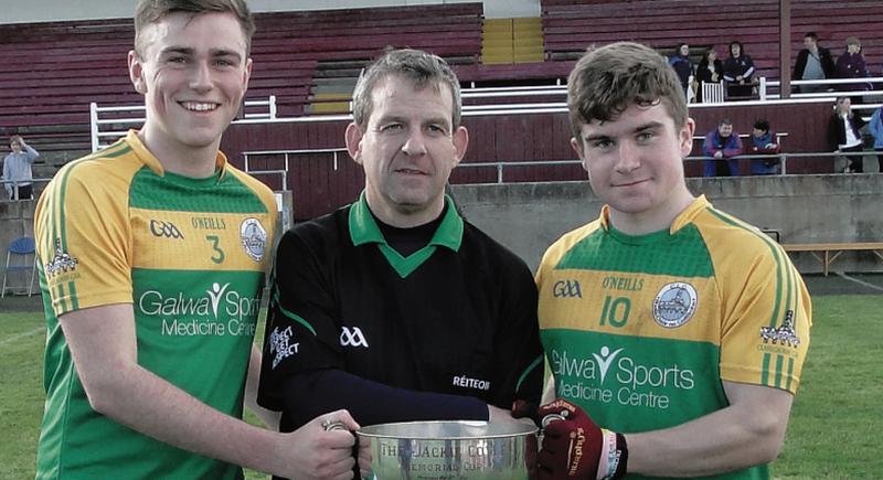 Claregalway minor football joint captains Thomas Coyle and Barry Goldrick are presented with the Cup by Padraic Kelly, North GPC Secretary.