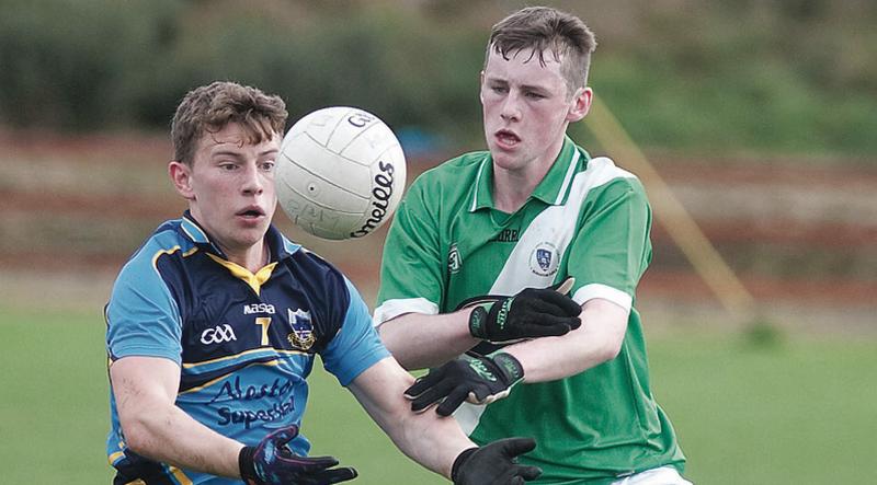 Salthill Knocknacarra's Eamon Kelly battling for possession with Moycullen's Ciaran Scully in the West Minor A Football Final in Rosmuc on Saturday. Photos: Iain McDonald.