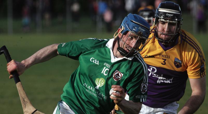 Ballindereen's Shane Coen tries to break free from Kinvara's Ger Mahon during Saturday's intermediate hurling semi-final in Gort. Photo: Enda Noone.