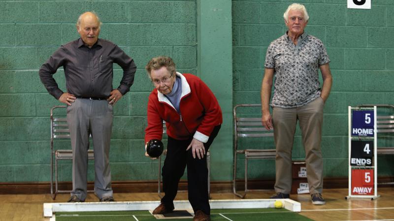 Peggy Costello in action at Salthill Active Retirement Association's short mat bowls meeting at Galway Lawn Tennis Club last Friday morning. Watching on are Tom Quigley (left) and Kevin O'Hare (right).