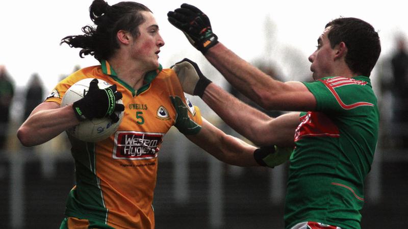 Corofin defender Kieran Molloy fends off St. Brigid's Garvan Dolan during the Connacht Club Football Final at Carrick-on-Shannon on Sunday. Photo: Enda Noone.