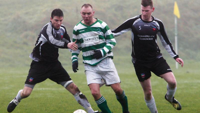 West United's James Ryan is challenged by Corrib Celtic's Sean O'Flaherty (left) and Stephen Moylan during the clubs' Premier Division clash at South Park. Photo: Joe O'Shaugghnessy.