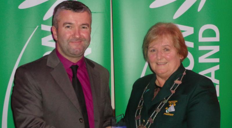 Badminton Ireland President Betty Thompson presents Shane Wynne of Oranmore Badminton Club with the 'Coach of the Year' award at a function in the Hilton Hotel, Dublin Airport last Saturday.