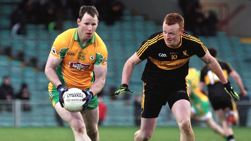 Corofin substitute Greg Higgins secures possession ahead of Dr. Crokes' Johnny Buckley during Saturday's All-Ireland Club football semi-final at the Gaelic Grounds, Limerick. Photo: Enda Noone.