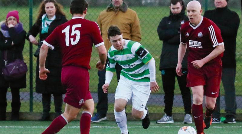 Athenry's Alan O'Donovan breaking away from Castlebar Celtic's Anthony Johnston with team-mate Conor Cannon in close attendance during the Connacht Junior Cup tie at Fahy's Field on Sunday. PHOTO: EIREFOTO