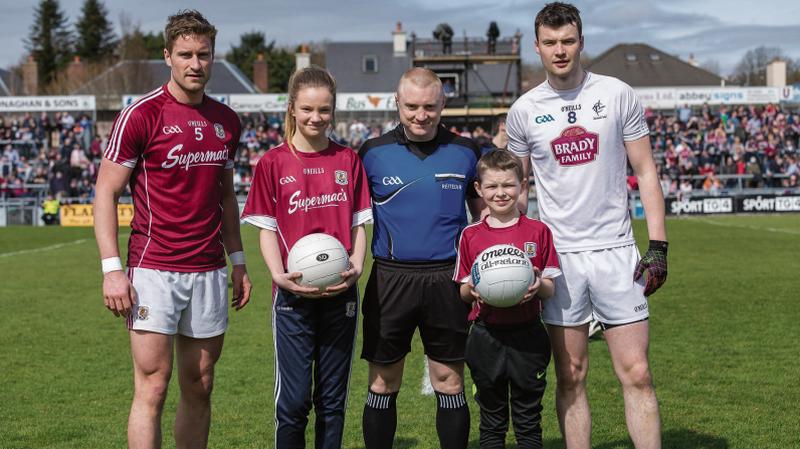 On the ball . . .Amy Kemp, age 13, from Kilkerrin/Clonberne Ladies football club and nine year old Darragh Brogan from Miltown presenting the match ball to referee Barry Cassidy with Galway captain Gary O Donnell and Kildare captain Fionn Dowling. The two were selected following a competition run by Galway GAA sponsor Supermac's.