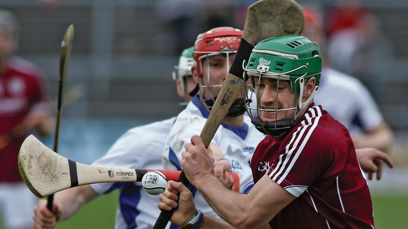 Galway's David Burke is about to launch an attack as Waterford's Seamus Keating closes in during Sunday's National League quarter-final at Pearse Stadium.