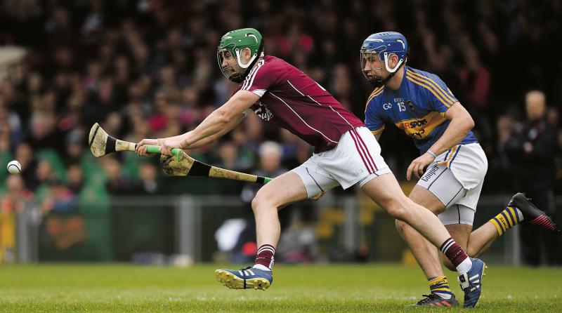 Galway defender Adrian Tuohy is at full stretch against Tipperary's John McGrath during Sunday's National Hurling League Final at the Gaelic Grounds. Photo: Ray McManus/Sportsfile.