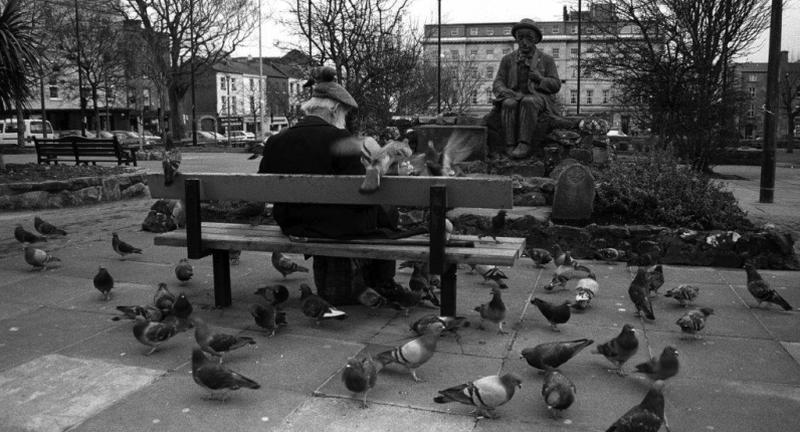 The original statue of Pádraic Ó Conaire in Eyre Square in the 1980s prior to having its head removed by vandals in 1995. The repaired original is now in Galway Museum but a bronze replica is shortly to be installed at Eyre Square.