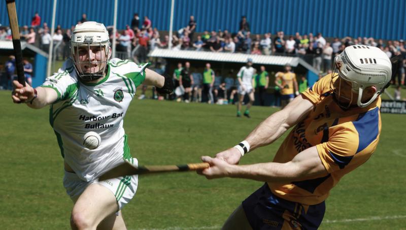 Jeffrey Lawless of Sarsfields moves in to try and block Portumna's Andy Smith in Loughrea on Sunday. Photos: Hany Marzouk.