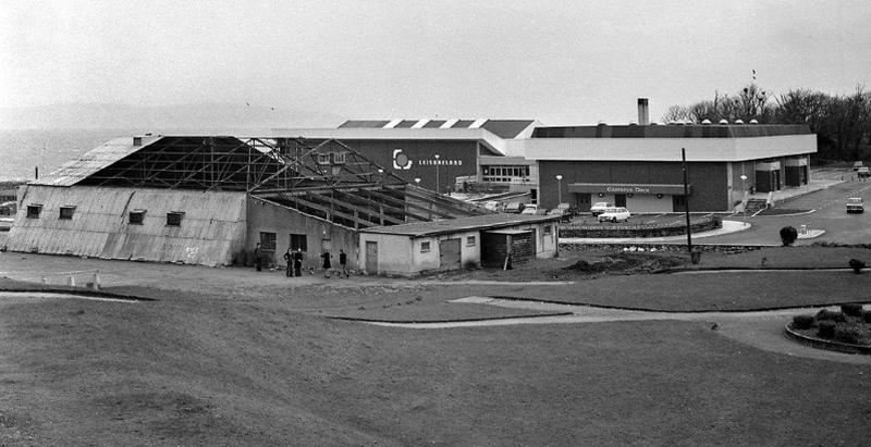 The demolition of the Pavilion Ballroom, better known as The Hangar, in Salthill Park in the 1970s. A former RAF Aerodrome in Oranmore, it was purchased by Galway Urban Council in 1924 for £400. Over the subsequent half century a succession of big international acts graced the Hangar stage — Jim Reeves, Chubby Checker, Bill Haley, Johnny Cash, Horslips, Thin Lizzy, Rory Gallagher, etc as well as all the top names from the showband era. The spartan facilities of The Hangar were put in stark perspective with the opening of the adjacent Leisureland in 1974 which soon became the city's prime concert venue for a decade or more.