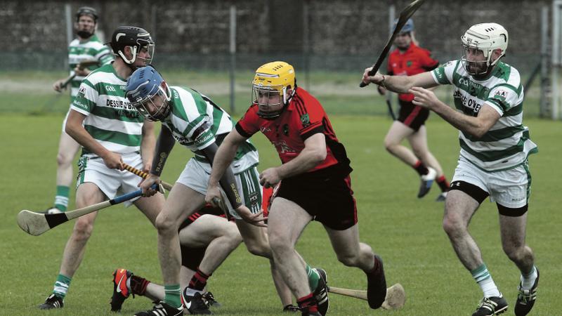 Tommy Larkins' Darragh Kelly races away with possession as Mullagh’s Noel Mannion and Alan Whyte close in. Photos: Enda Noone.