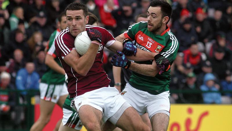 Galway’s Fiontan Ó Curraoin retains possession despite the best efforts of Mayo's Kevin McLoughlin. Photos: Enda Noone.