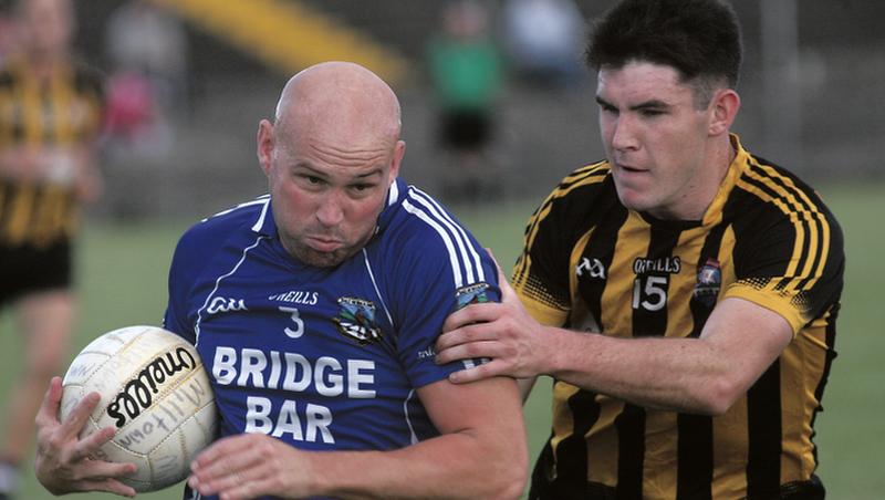 Mountbellew-Moylough’s Barry McHugh tries to halt the progress of Milltown's Darren Mullahy during Saturday's senior football championship tie at Tuam Stadium. Photos: Enda Noone.