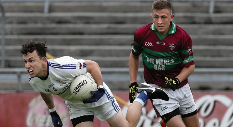 Micheál Breathnach's Cian Ó Griallais wins this diuel for possessio with Mike Fahy of St James' during Sunday's senior football championship clash at Pearse Stadium. Photos: Joe O'Shaughnessy.