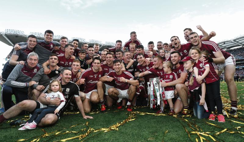 The Galway senior hurling squad celebrate with members of the backroom team and young supporters after their All-Ireland final victory over Waterford at Croke Park on Sunday. Photo: Joe O'Shaughnessy,