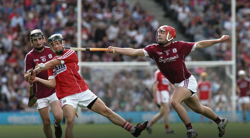 Galway midfielder Conor Fahy is at full stretch as he tries to hook Cork's Barry Murphy during Sunday's All-Ireland minor hurling final at Croke Park. Photos: Joe O'Shaughnessy.