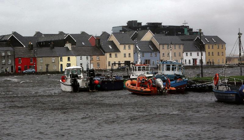 Boats bumping about in the water at the Claddagh, Galway, with the Long Walk in the background during Ophelia's tenure in the West on Monday last. PHOTO: HANY MARZOUK.