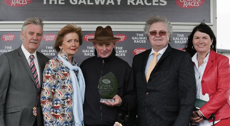 Frank Berry, Racing Manager for JP McManus, accepts the winners trophy after Persistent won The Galway City and Salthill Publicans Charity Handicap Hurdle at Ballybrit on Tuesday. Also included are, Terry and Patsy Tyson, Tom McDonagh and Triona Cosgrove.