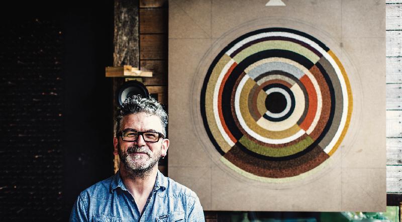 Artist and former chef Frank Corry with oneof the pieces created in conjunction with Loam Restaurant.