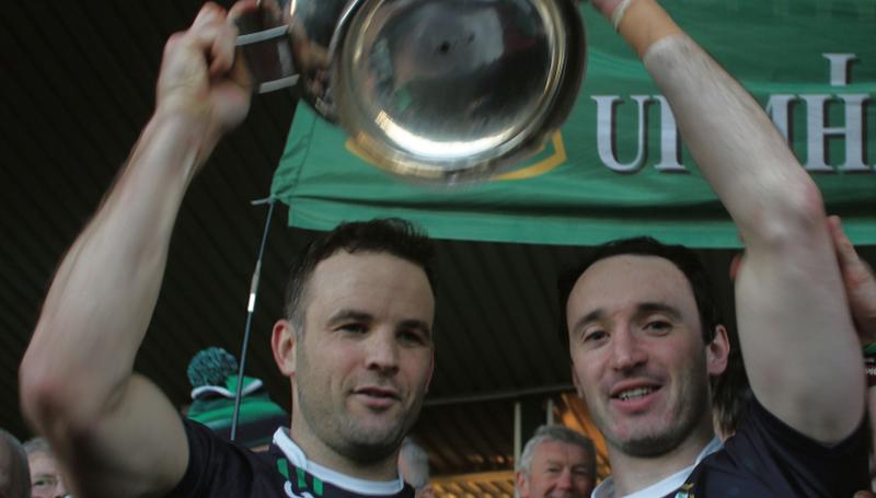 Liam Mellows joint captains, David Collins and Aonghus Callanan, raise the Tom Callanan Cup aloft after the club's county final victory over Gort at Pearse Stadium on Sunday. Photo: Enda Noone.