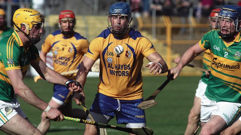 Portumna's Peter Smith comes under pressure from the Gort duo of Keith Killilea and Sylvie Og Linnane. Photos: Enda Noone.