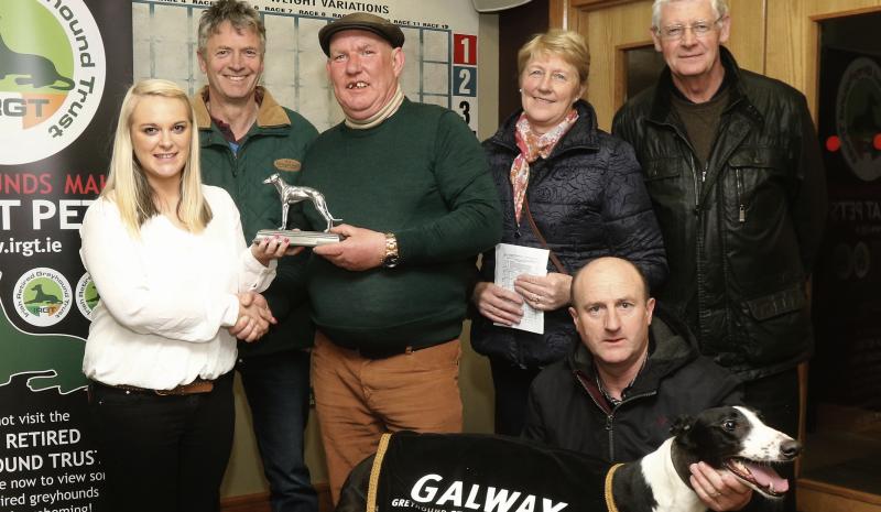 Laura Connolly presents the winning trophy to Speedie O'Farrell, Monivea, after Jumeirah Big Tom won the Fundraising at the Dogs A5/A6 Final at Galway Greyhound Stadium. Also included are Bobby Collins, Marian and Danny Potter and Liam Carr. Photo: Iain McDonald.