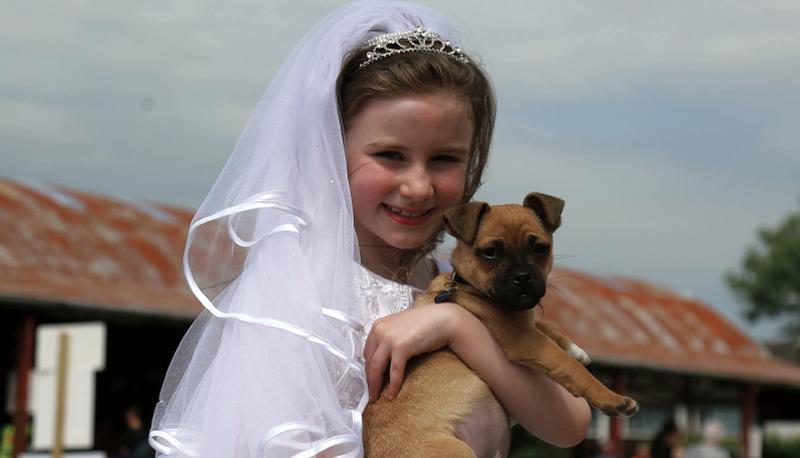Robyn Hickey from Galway city showing her dog at Athenry Agricultural Show after her Holy Communion in Galway at the weekend. Photograph: Hany Marzouk.