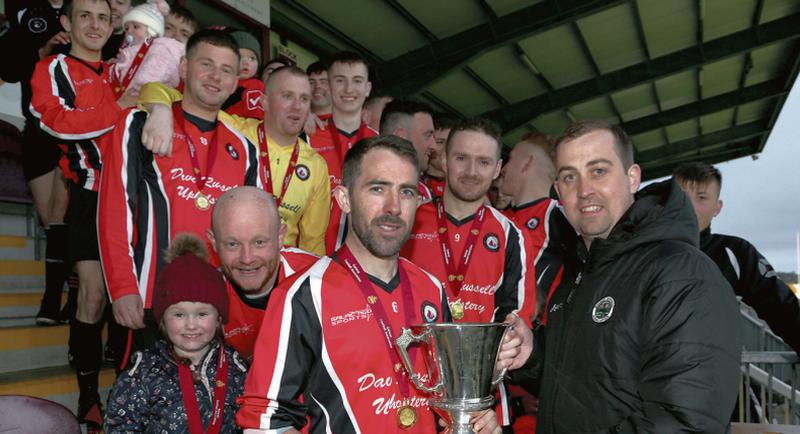 Tom Trill, Acting Chairman, Galway FA, presenting the Joe Ryan Memorial Cup to Anthony Connolly, Captain of the MacDara team after they defeated Kinvara in the final. Photos: Joe O'Shaughnessy.
