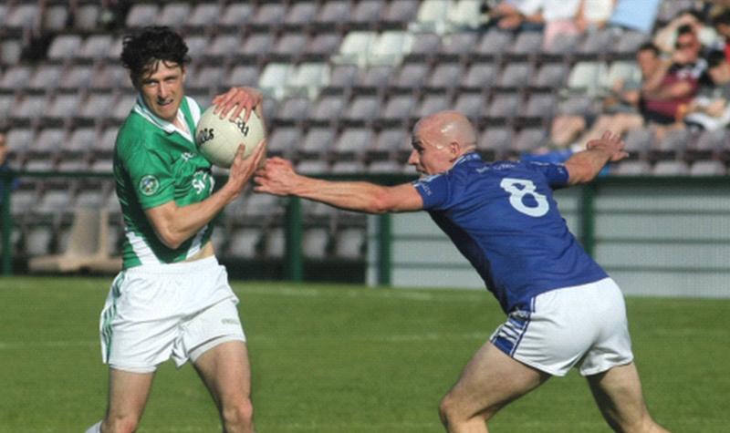 St Michaels Frank Daly puts in a challenge on Moycullen's Conor Bohan.