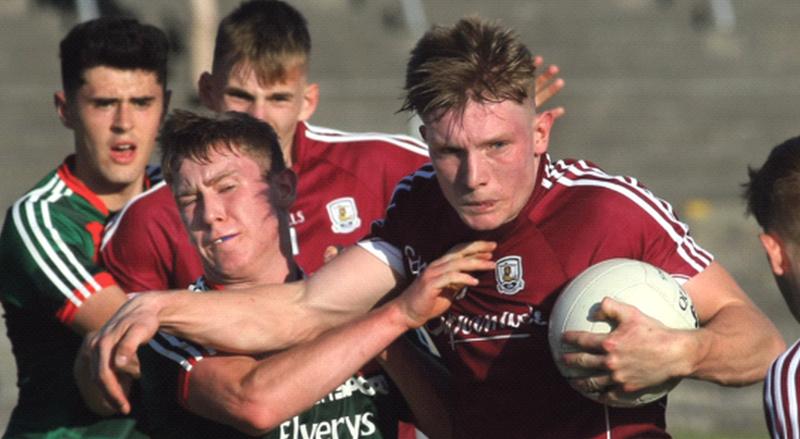 Galway’s Conor Raftery comes under strong pressure from Mayo's Frank Irwin during the Connacht minor football championship tie at Tuam Stadium on Friday evening. Photos: Enda Noone.