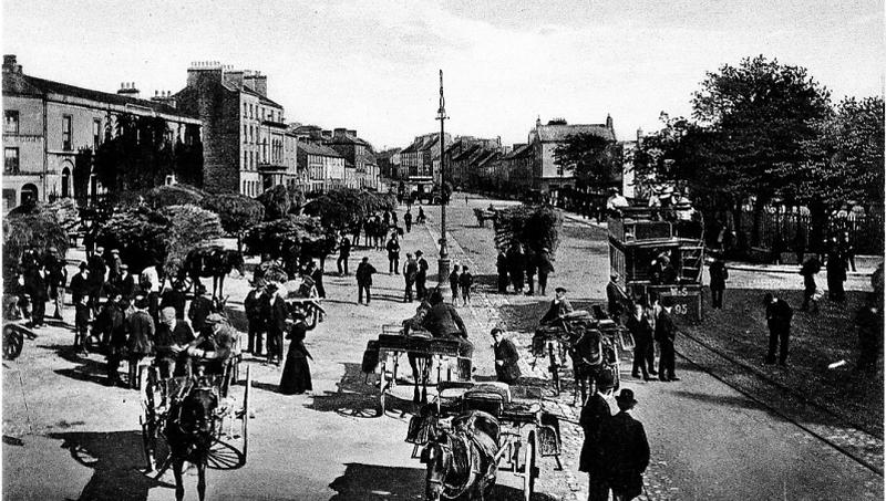 Eyre Square on a Fair Day in the 1890s when the item of trade appears to have been hay. Note the tram on its way to Salthill to the right of the photo.