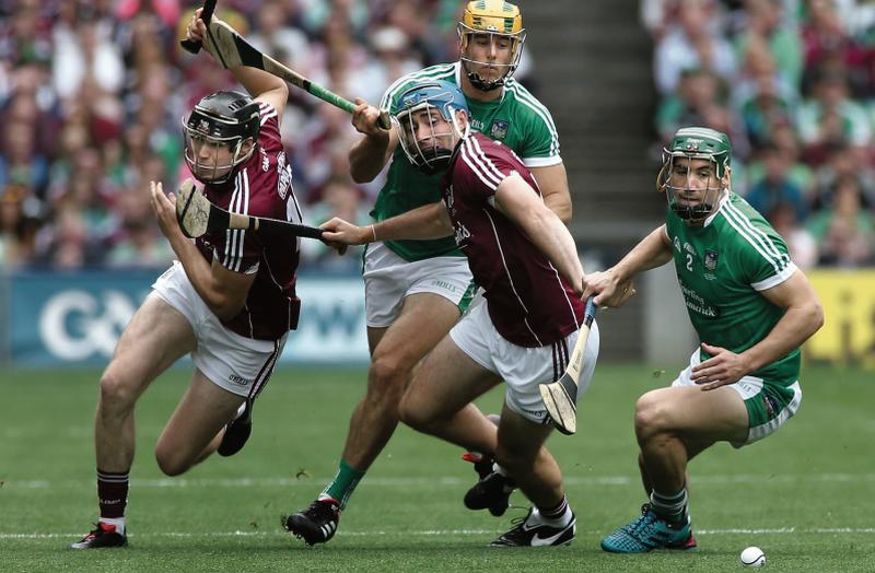 Galway's Joseph Cooney and Conor Cooney in a battle for possession with Limerick's Dan Morrissey and Sean Finn during Sunday's All-Ireland final at Croke Park. Photo: Joe O'Shaughnessy