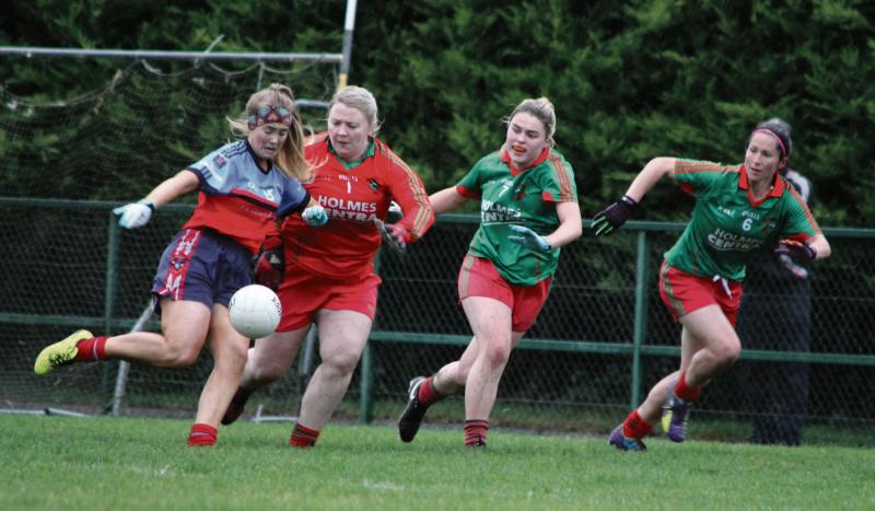 Tuam Cortoon full forward, Ciara Maloney fires a shot past St Brendan's goalkeeper Sinead Kelly.