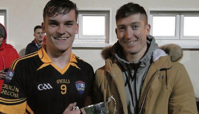 Galway footballer Johnny Heaney presents the County Minor B Cup to Mountbellew/Moylough captain Oran O'Reilly after their final victiory over St James' in Headford.