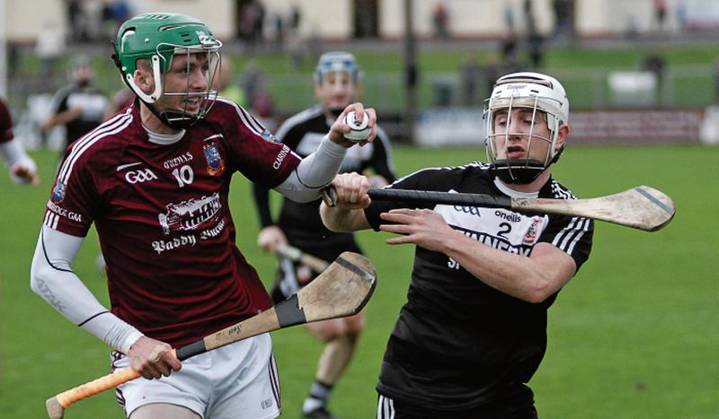 Niall Armstrong of Clarinbridge tries to hold off the challenge of Richie Lally of Pearses on Sunday. Photos: David Cunniffe.