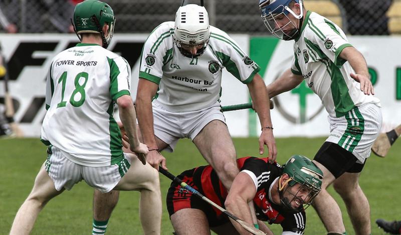 Cappataggle's James Garvey finds himself surrouned by the Sarsfields' trio of Eric Kenny, Peter English and Noel Kelly in Kenny Park on Sunday. Photos: Joe O'Shaughnessy.