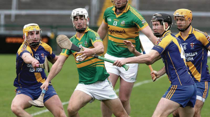 Gort's Jack Commins tries to secure possession despite the close attention of Loughrea's Conor Jennings, Kelan Jennings and Paul Hoban. Photos: Joe O'Shaughnessy.