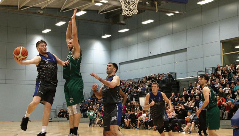 Maree's Charlie Crowley tries to hook a lay-up past Moycullen's Dylan Cunningham in the NUIG Kingfisher last Saturday.