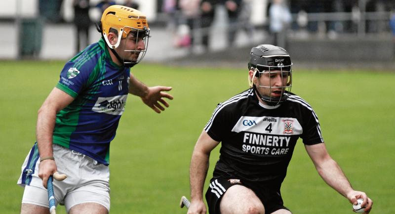 Damien Wynne of Pearses takes control as John Conroy of Tynagh-Abbey/Duniry closes in. Photos: David Cunniffe.